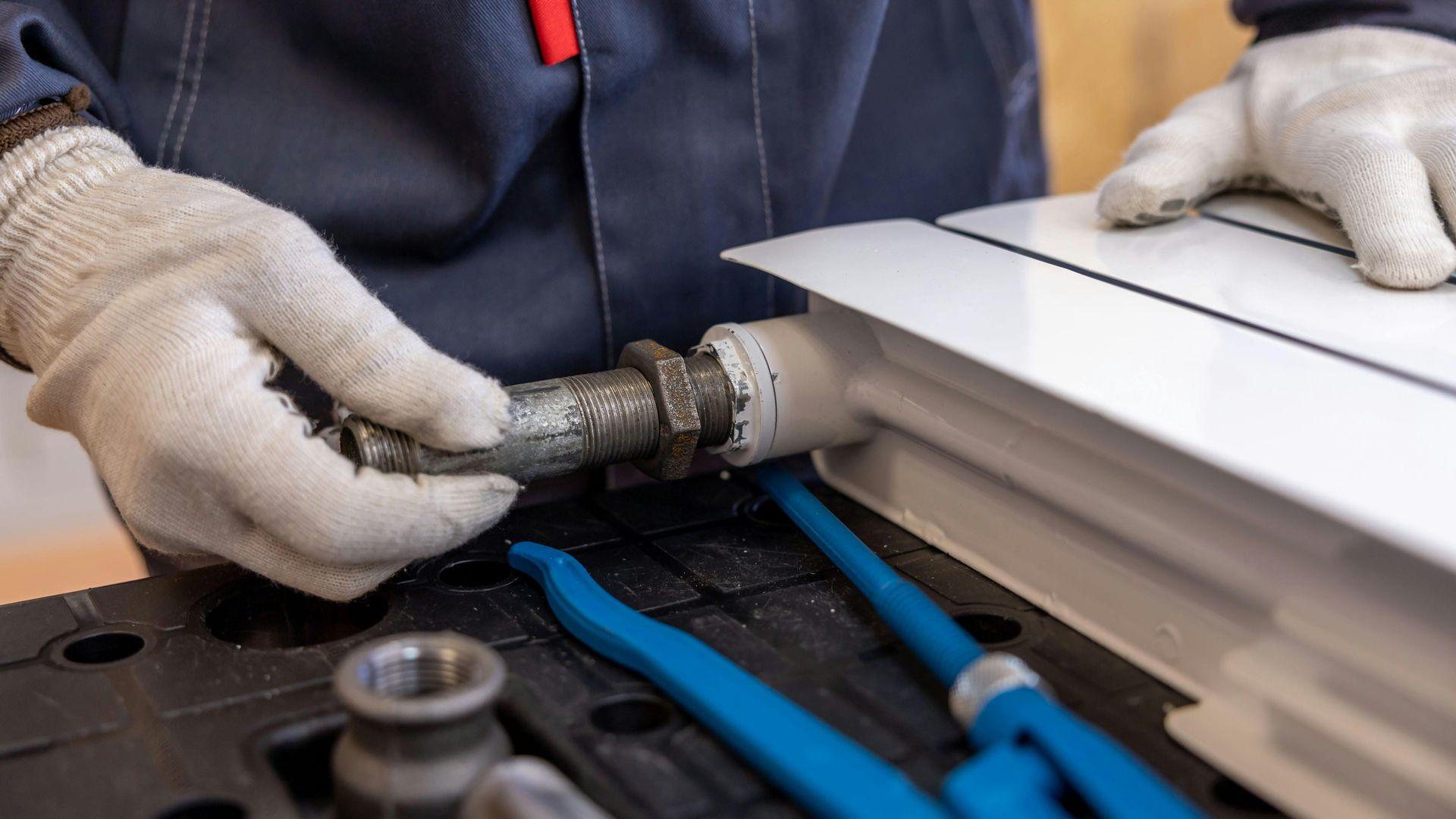 Plumber installing a pipe